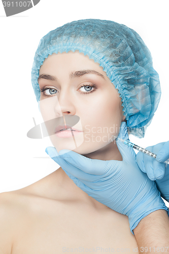 Image of Attractive woman at plastic surgery with syringe in her face