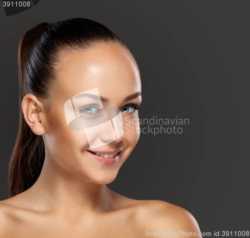 Image of visagist making makeup for model with aerograph