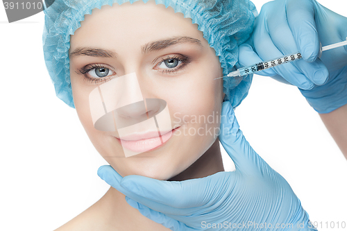 Image of Attractive woman at plastic surgery with syringe in her face