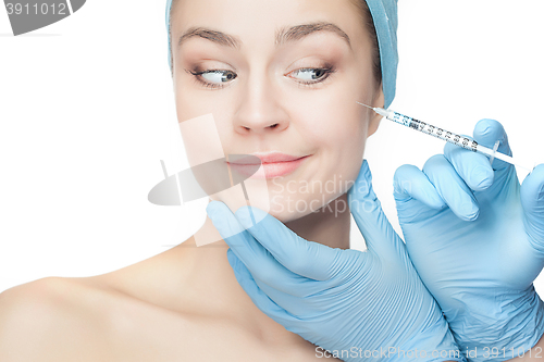 Image of Attractive woman at plastic surgery with syringe in her face