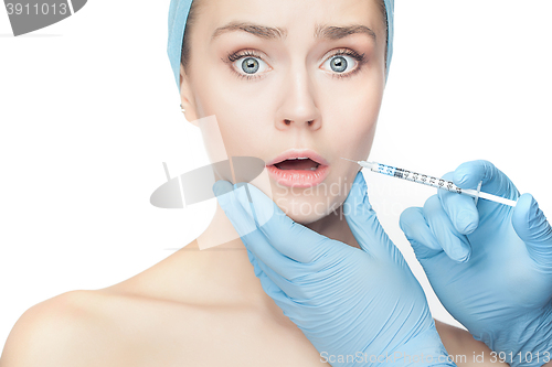 Image of Attractive woman at plastic surgery with syringe in her face