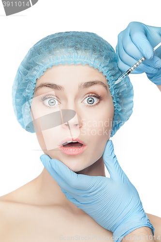 Image of Attractive woman at plastic surgery with syringe in her face