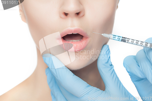 Image of Attractive woman at plastic surgery with syringe in her face