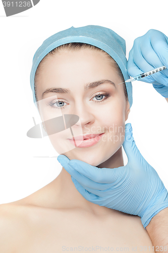 Image of Attractive woman at plastic surgery with syringe in her face