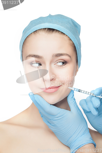 Image of Attractive woman at plastic surgery with syringe in her face