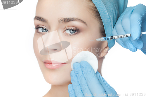 Image of Attractive woman at plastic surgery with syringe in her face