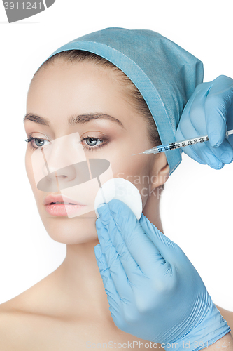 Image of Attractive woman at plastic surgery with syringe in her face