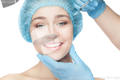 Image of Attractive woman at plastic surgery with syringe in her face