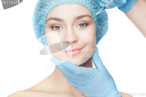 Image of Attractive woman at plastic surgery with syringe in her face