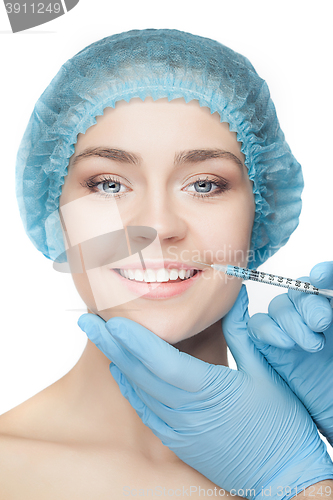 Image of Attractive woman at plastic surgery with syringe in her face