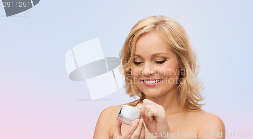 Image of happy woman with cream jar