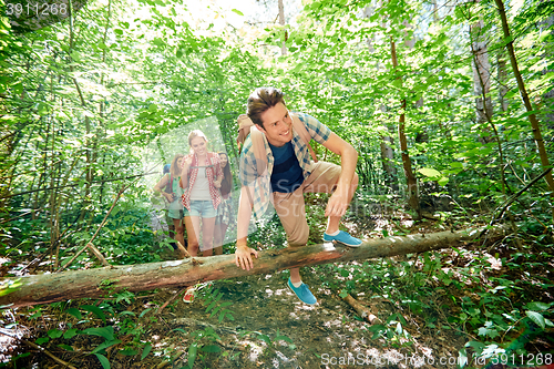 Image of group of smiling friends with backpacks hiking