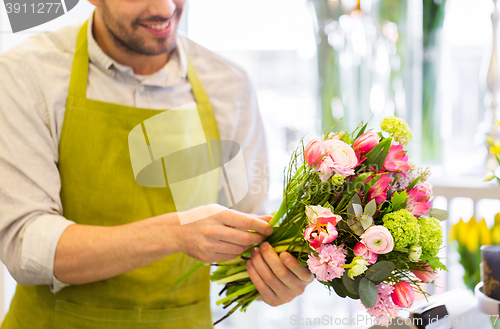 Image of close up of florist man with bunch at flower shop