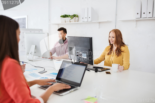 Image of creative team with computers working at office