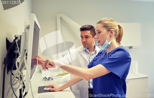 Image of dentists with x-ray on monitor at dental clinic