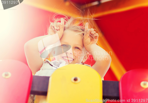 Image of happy little girl on children playground