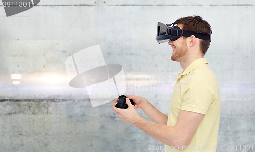 Image of man in virtual reality headset and gamepad playing
