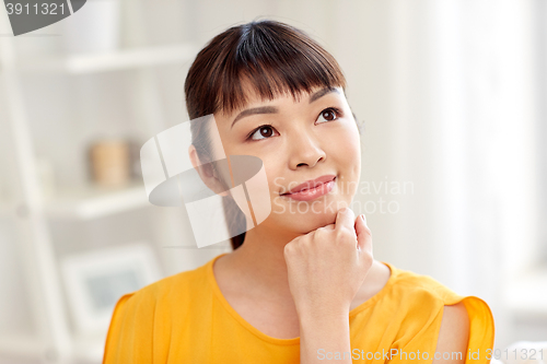 Image of happy asian young dreaming woman face at home