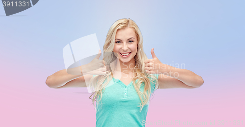 Image of happy woman or teenage girl showing thumbs up