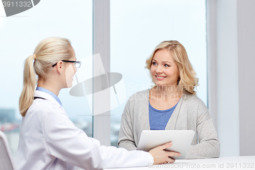 Image of doctor with tablet pc and woman at hospital