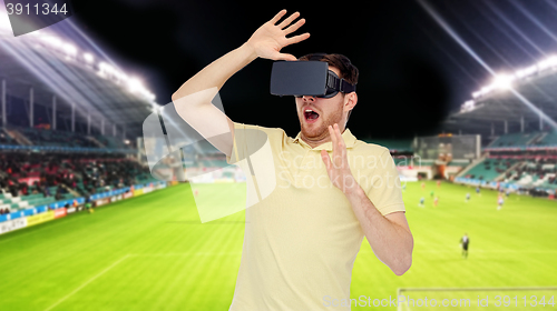 Image of man in virtual reality headset over football field