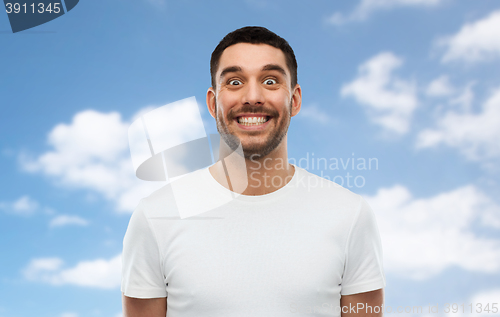 Image of man with funny face over blue sky background