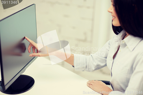 Image of close up of woman with computer monitor in office
