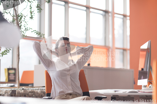 Image of happy young business woman relaxing and geting insiration