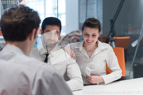 Image of young couple signing contract documents on partners back