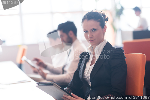 Image of business woman on meeting  using tablet