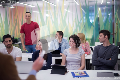 Image of teacher with a group of students in classroom