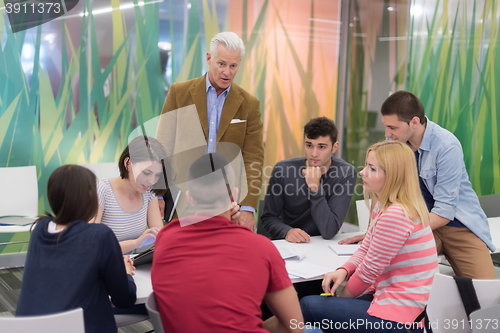 Image of teacher with a group of students in classroom