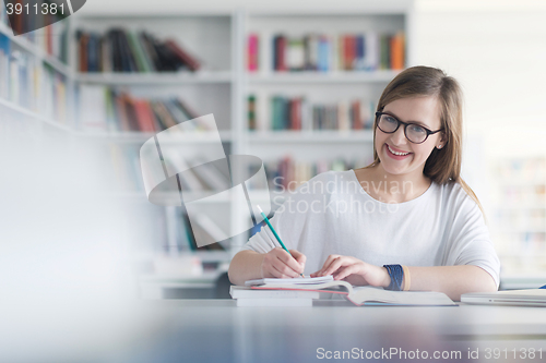 Image of female student study in school library