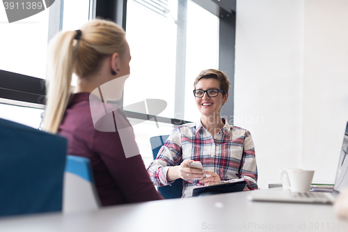 Image of young business woman at modern office meeting room