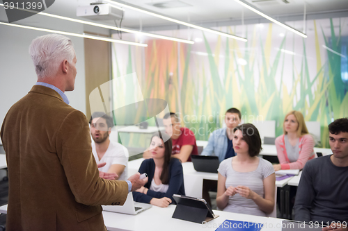 Image of teacher with a group of students in classroom