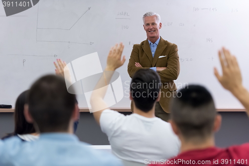 Image of teacher with a group of students in classroom