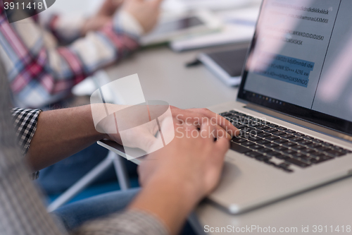 Image of close up of business man hands typing on laptop with team on mee