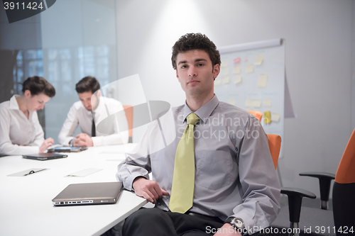 Image of portrait of young business man at modern office