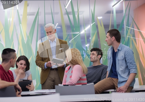 Image of teacher with a group of students in classroom