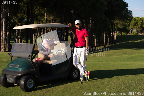 Image of couple in buggy on golf course