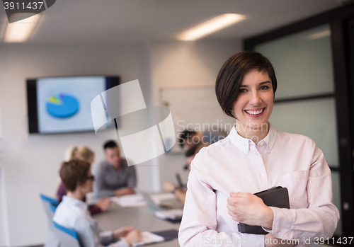 Image of hispanic businesswoman with tablet at meeting room