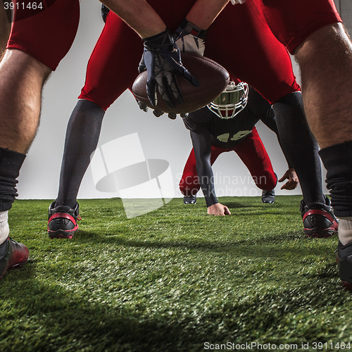 Image of The three american football players in action