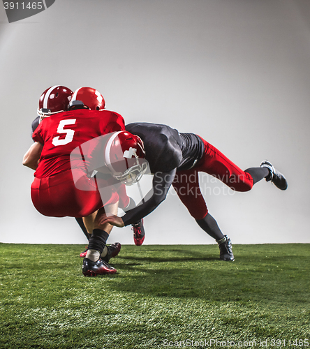 Image of The three american football players in action