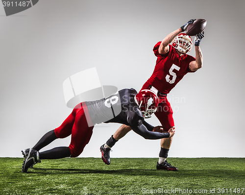 Image of The two american football players in action