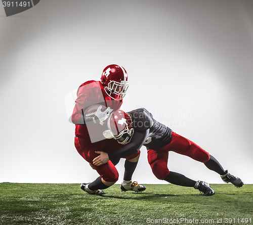 Image of The two american football players in action