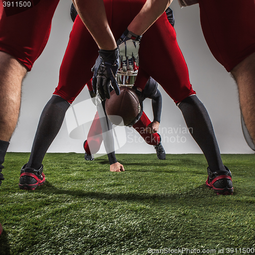 Image of The three american football players in action