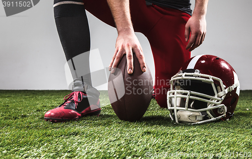 Image of The american football player with ball