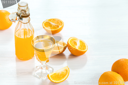 Image of Glass of orange liqueur. Selective focus