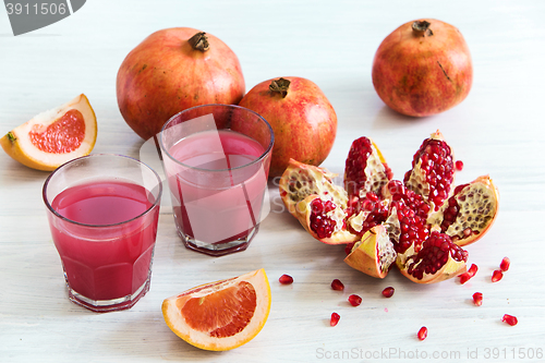 Image of Pomegranate liqueur in a glasses on wooden table. Selective focus.