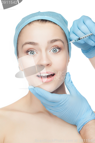 Image of Attractive woman at plastic surgery with syringe in her face